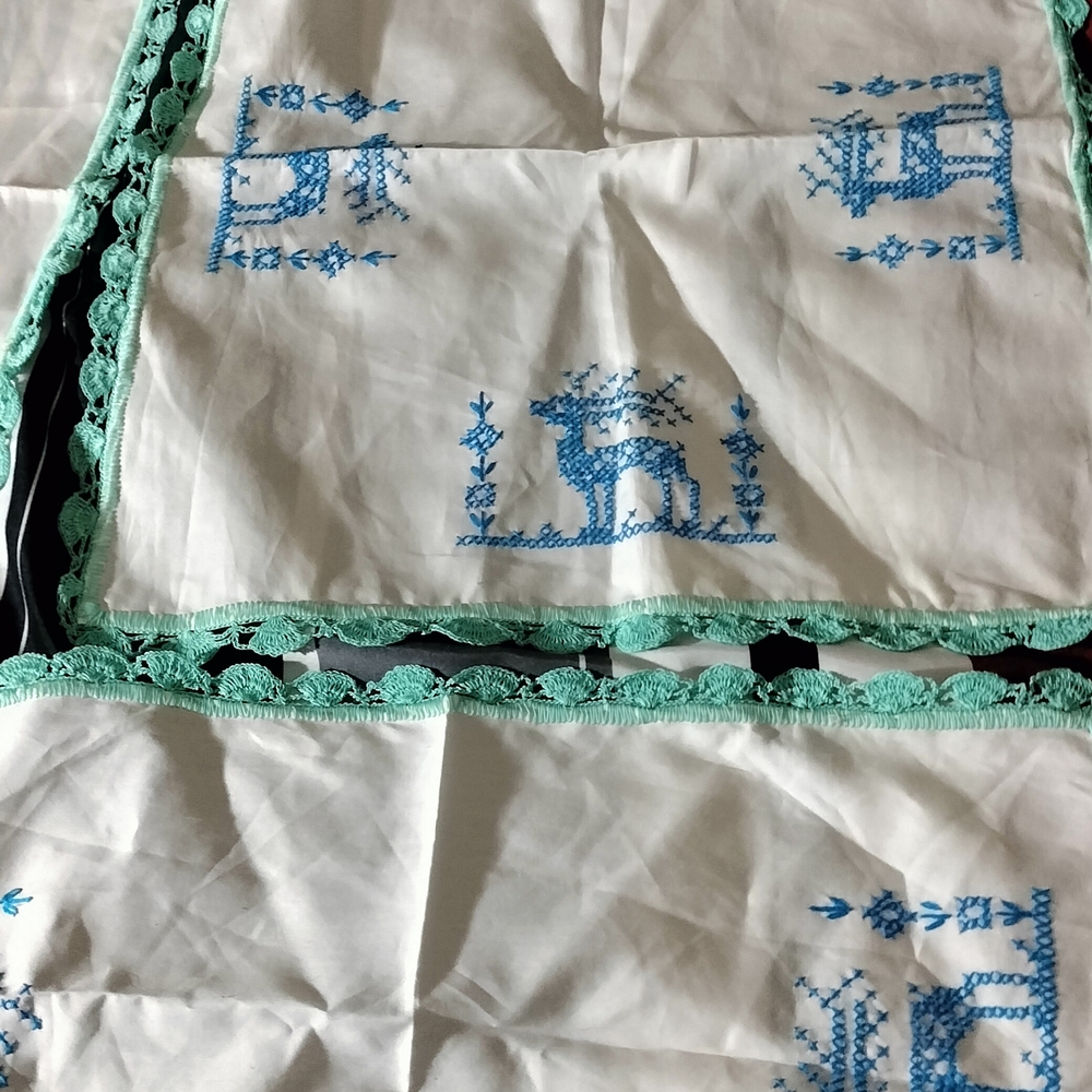 Embroidered White and Blue Table Linens with Green Trim